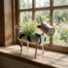 Painted cow planter with flowers for a cheerful windowsill display