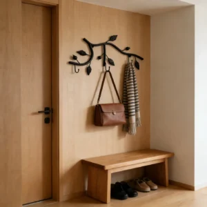Rustic branch wall hook rack holding a bag and scarf in an entryway