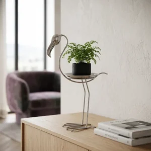 Silver crane plant stand with tray holding a small potted fern