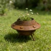 Rustic UFO planter with flowers for whimsical garden decor
