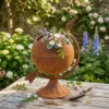 Rustic globe planter with flowers for garden decor