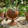 Rustic globe planter with flowers for garden decor