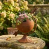 Rustic globe planter with flowers for garden decor