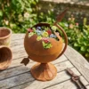 Rustic globe planter with flowers for garden decor