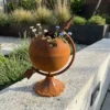 Rustic globe planter with flowers for garden decor